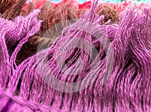 Tassel on the edge of the rug with soft purple, brown, red cotton threads