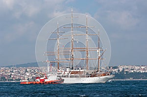 Tug Alongside Sailing Ship