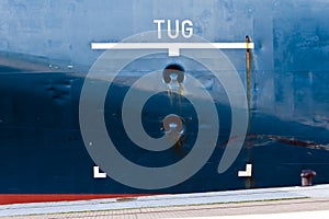 Tug area sign on ship hull.