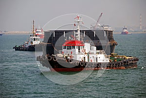 Tug and barge in Singapore anchorage.