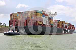 Tug Boat Assists Container Ship on Panama Canal