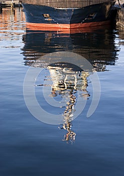 Tug boat and blue water reflection