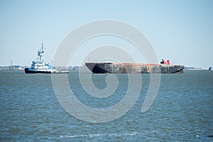 Tug boat and large container ship in chaleston sc