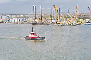 Tug boat and oil rigs at the port