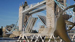 Tug boat passes under Tower Bridge