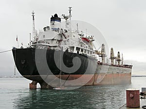 Tug boat towing bulk carrier vessel.