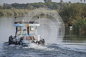 Tug boat towing yacht on nile river in Egypt
