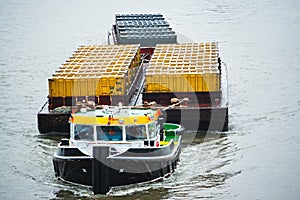 Tug boat transporting containers