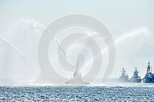 Tug boats spraying jets of water, demonstrating firefighting water cannons, fire boats spraying foam