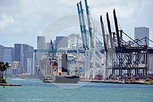 Tug Guiding a Container Ship to a Loading Pier t the Port of Miami