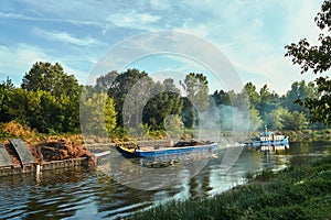 A tug hauling two cargo barges on the Warta river