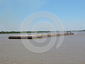 Tug pusher CEIBO and convoy of barges in navigation along the water way Paraguay Parana Hidrovia photo