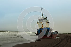 The tug ran aground at low tide in the Pacific ocean. Average plan.