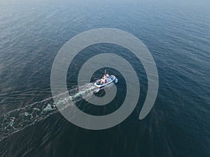 A tug sails on the sea in the Paldiski area at sunset. Drone photo