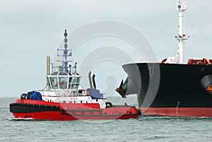 Tug towing a tanker close up