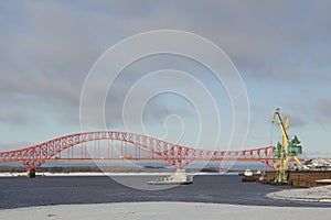 A tugboat against the background of the bridge in Ugra