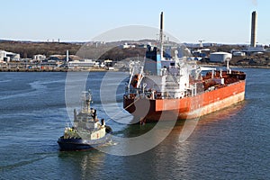 Tugboat with cargo ship