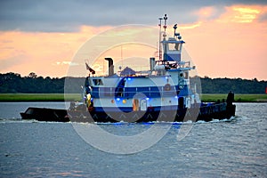 Tugboat cruising along the river background