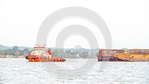 Tugboat dragging empty barge at Mahakam River, Samarinda, Indonesia