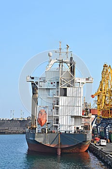 Tugboat and freight train under port crane