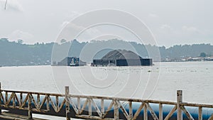 Tugboat pull heavy loaded barge of coal