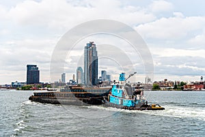 Tugboat pushing barge in New York City