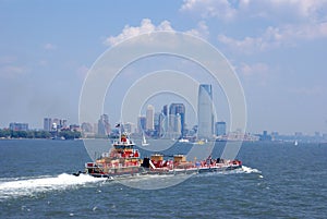 Tugboat pushing barge in New York Harbor