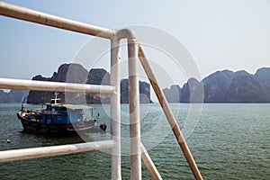 A tugboat sailing through the islands in Ha Long Bay