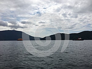 Tugboat shipping lumber across Howe sound in British Columbia, C