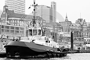 tugboat at the St. Pauli LandungsbrÃ¼cken piers in Hamburg in black and white