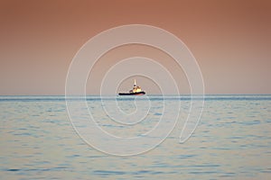 Tugboat on sunset