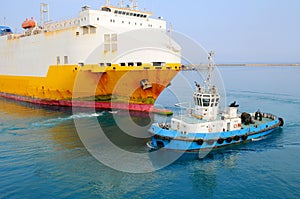 Tugboat towing a ship photo