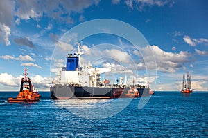 Tugboat towing a tanker