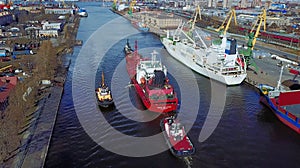 Tugboats assisting cargo ship sea in the morning.