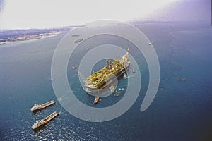 Tugboats carrying oil & gas FPSO rig