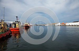 Tugboats moored in port, nobody inside