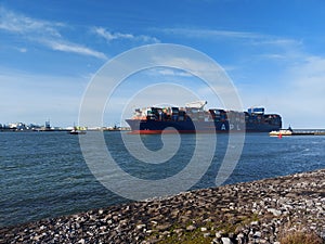 Tugship brings APL Merlion container ship inside the port of Rotterdam