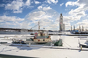 Tugtoat docking in the port of montreal in winter before the clock tower