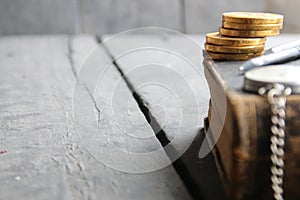 Tuition fees idea, book on wooden table, blurred photo for background