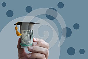 Tuition payments or scholarship concept. Money with graduation cap.