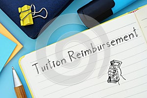 Tuition Reimbursement sign on the piece of paper