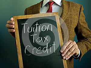 Tuition tax credit. The banker shows a handwritten inscription.