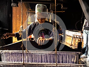 Tujia nationality Old woman weaving