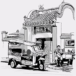 Tuk tuk driver eating at the door of a chinese temple in Bangkok