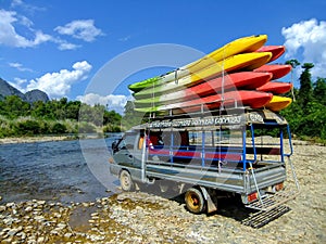 Tuk-tuk loaded with kayaks at Nam Song River near Vang Vieng, Vi