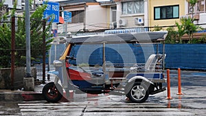 Tuk tuk taxi left unattended under the rain