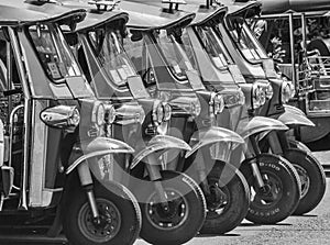 Tuk-tuks lined up in a row