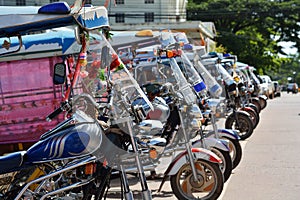 Tuk tuks lined up in a side ally