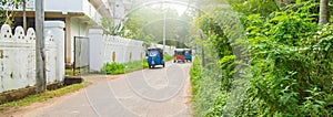 Tuk tuks ride along the road. Sri Lanka. Selective focus