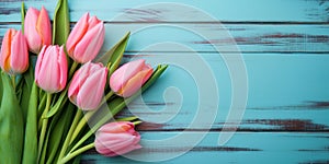 Tulip border with copy space. Bouquet of pink tulips flowers on turquoise blue vintage wooden background. generative ai. Beautiful